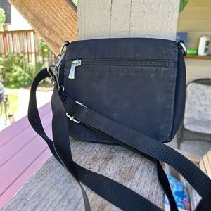 Travelon crossbody pouch. Small 7” by 6.5”.  Unisex